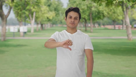 Disappointed-Indian-man-showing-thumbs-down