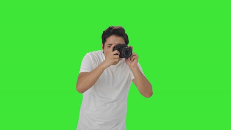 Indian-man-clicking-photos-using-camera-Green-screen