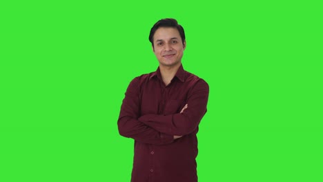 Portrait-of-Happy-Indian-teacher-standing-crossed-hands-Green-screen