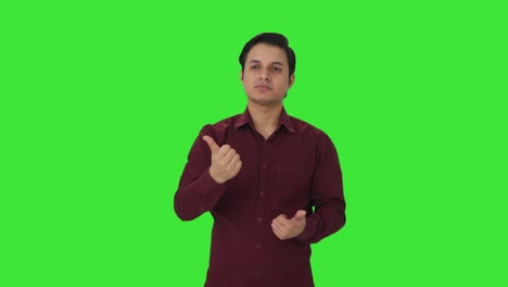 Disappointed-Indian-teacher-showing-thumbs-down-Green-screen