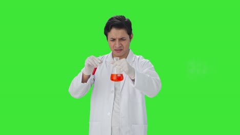 Confused-Indian-scientist-mixing-chemicals-for-experiment-Green-screen