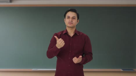 Disappointed-Indian-teacher-showing-thumbs-down
