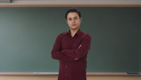 Portrait-of-confident-Indian-teacher-standing-crossed-hands