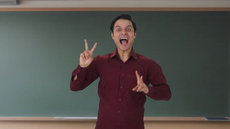 Happy-Indian-teacher-showing-victory-sign