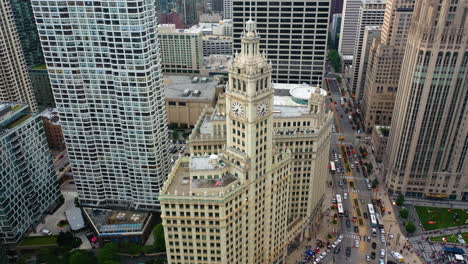 Aerial-view-around-the-Wrigley-building-clock-tower-in-cloudy-Chicago-Loop,-USA