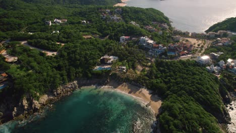 Aerial-view-of-the-bay-in-Huatulco,-Oaxaca,-a-paradisiacal-beach-with-blue-waters-on-the-Mexican-Pacific-coast
