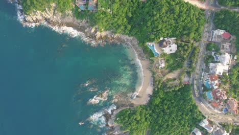 aerial-drone-footage-video-of-a-beach-with-rocks-landscape-in-oaxaca,-mexico,-travel-in-america-summer,-waves,-natural-park,-coast-in-the-pacific-ocean-with-no-people-huatulco-holidays