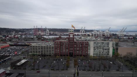 Wide-Angle-Aerial-orbit-of-Starbucks-Coffee-Headquarters-Port-of-Seattle-skyline,-dull-gray-skies