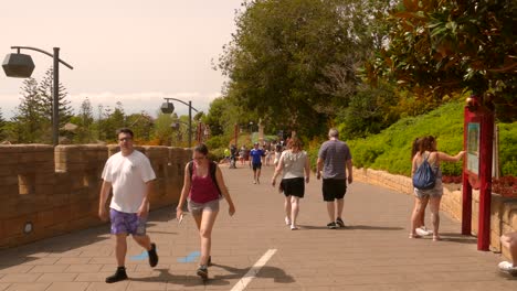 Pan-shot-of-tourists-walking-along-China-area-in-Port-Aventura-World-park-in-Salou,-Spain-on-a-sunny-day