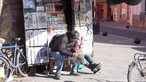 Newspaper-and-magazine-sales,-reading-the-news-at-newspaper-stand