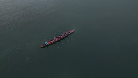Rowing-crew-working-in-synchrony-as-they-speed-along-water-surface