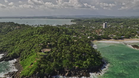 Mirissa-Sri-Lanka-Aerial-v8-flyover-the-coast-around-hillside-resorts-capturing-palm-fringed-landscape,-Weligama-Bay-and-oceanscape-views-of-tropical-paradise---Shot-with-Mavic-3-Cine---April-2023