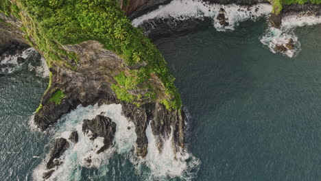 Maui-Hawaii-Aerial-v6-vertical-top-down-view-slow-motion-drone-flyover-coastline-capturing-Pailoa-point,-rocky-sea-cliff-wall,-ocean-waves-and-lush-vegetations---Shot-with-Mavic-3-Cine---December-2022