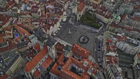 Prague-Czechia-Aerial-v82-birds-eye-view,-drone-flyover-and-around-famous-old-town-square-capturing-crowds-at-the-historic-center,-tilt-up-reveals-cityscape---Shot-with-Mavic-3-Cine---November-2022