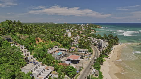 Mirissa-Sri-Lanka-Aerial-v3-flyover-A2-Matara-road-capturing-palm-lined-coast,-golden-beaches,-seaside-resorts-from-Udupila-to-Bandaramulla-and-serene-oceanscape---Shot-with-Mavic-3-Cine---April-2023