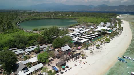 Aerial-over-beach-at-Gili-Meno,-nestled-among-the-idyllic-Gili-Islands-of-Indonesia,-stands-as-a-serene-and-enchanting-paradise-for-travelers-seeking-an-escape-from-the-ordinary
