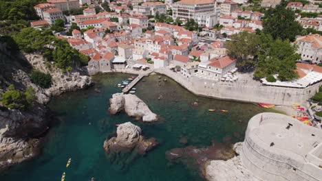 Kayaks-depart-Kolorina-beach-next-to-Fort-Bokar-in-Dubrovnik,-Croatia