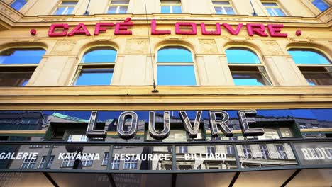 Front-of-Café-Louvre,-national-monument-of-the-Czech-Republic,-old-café-in-the-city-of-Prague,-red-sign