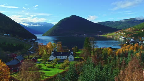 Aerial-view-over-a-town-covered-in-autumn-colors,-sunny-fall-day-in-Central-Norway