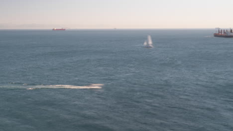 Moving-boats-and-cargo-ship-in-open-sea-near-Spain,-time-lapse