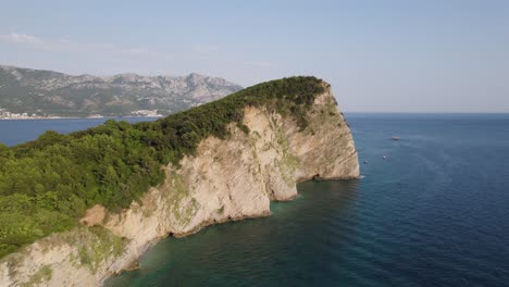 Cliff-aerial-view-in-Budva-Sveti-Nikola-Island,-Montenegro-azure-coast