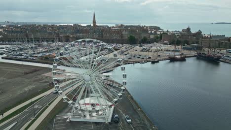 Ferris-wheel-with-Saint-Malo-port-and-old-city-in-background,-Brittany-in-France