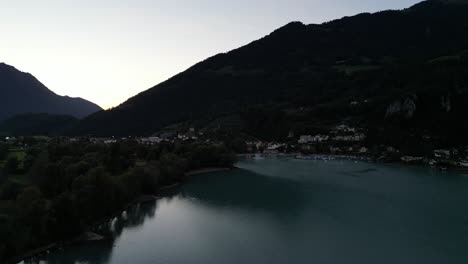 Serene-drone-view-of-dark-mountains-over-Walensee-lake,-Switzerland-in-the-early-morning