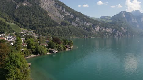 Drone-flying-over-Weesen-town-based-near-shore-of-Walensee-lake,-Switzerland