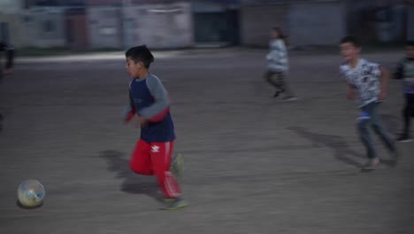 Children-of-Villa-Fiorito,-where-Diego-Maradona-was-born-and-raised,-continue-to-play-football-in-the-streets