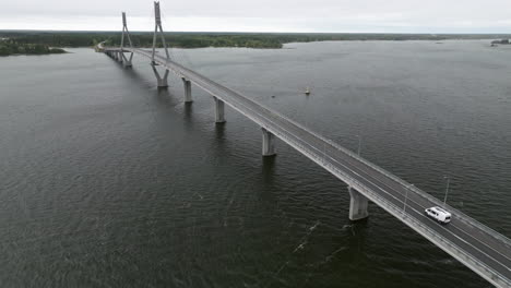 A-White-Van-Driving-Across-Replot-Bridge-During-Cloudy-Day-In-Finland,-Northern-Europe