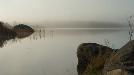 Autumn-stillness.-Foggy-landscape-near-lake.-Static-background