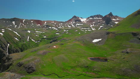 Aerial-drone-cinematic-high-altitude-Ice-Lake-Basin-Island-Lake-trail-lush-green-hike-Silverton-Ouray-Red-Mountain-Pass-Colorado-dreamy-heavenly-Rockies-scene-summer-peaks-forward-motion