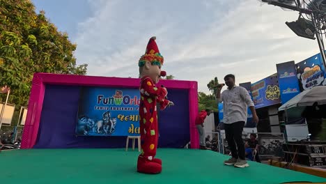 A-clown-joker-in-an-amusement-park-is-entertaining-young-children-wearing-a-joker-clown-costume