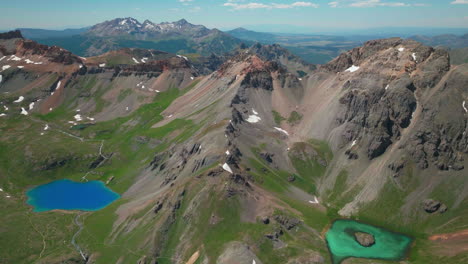 Aerial-drone-cinematic-high-altitude-Ice-Lake-Basin-Island-Lake-trail-unreal-blue-water-hike-Silverton-Ouray-Red-Mountain-Pass-Colorado-dreamy-heavenly-Rockies-scene-summer-peaks-backward-slowly