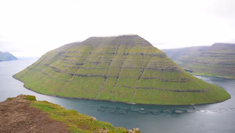 Stunning-view-of-Kunoy-Island-surrounded-by-clouds-from-top-of-Klakkur-Mountain,-Faroe-Islands
