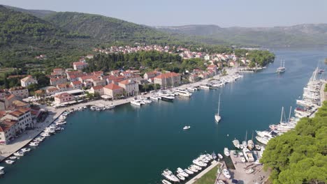 Croatia,-Hvar-Island,-Stari-Grad-bay-with-yachts-and-historic-buildings