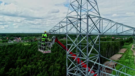 Workers-attach-the-cables-for-the-high-voltage-lines-to-the-poles