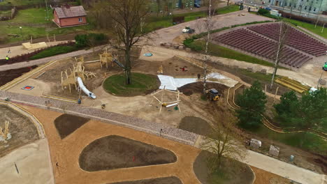 Aerial-view-overlooking-a-bulldozer-moving-soil-on-a-park-construction-site