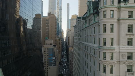 Aerial-view-flying-in-middle-of-buildings,-on-the-58th-st-of-Manhattan,-New-York