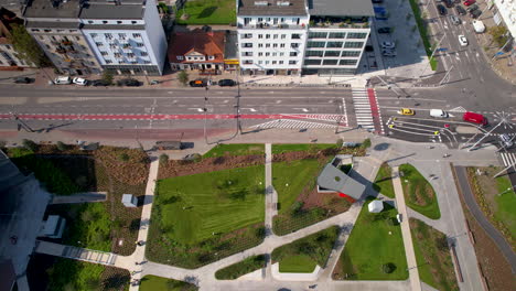 Aerial-view-of-Gdynia's-central-park,-showcasing-modern-buildings,-a-bustling-intersection,-and-green-spaces-amidst-the-urban-environment