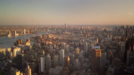 Aerial-view-of-the-New-York-skyline,-empire-state-building,-during-sunset-in-the-summer-time