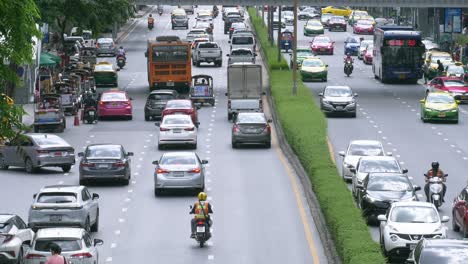 Traffic-slowly-building-up-in-front-of-MBK-shopping-centre-near-an-intersection-in-Pathum-Wan-District-in-Bangkok,-Thailand