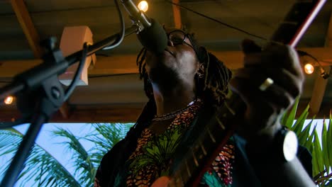 Reggae-artists-with-dreadlocks-strums-as-he-sings-bobbing-to-the-beat