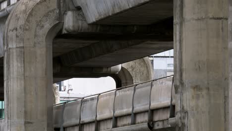 BTS-skytrain-moving-slowly-on-the-elevated-rail-tracks-to-its-destination-in-Bangkok,-the-capital-city-of-Thailand