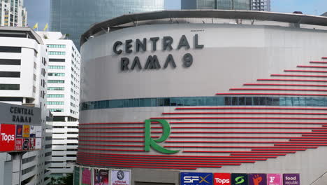 Primer-Plano-De-La-Vista-Frontal-Del-Centro-Comercial-Central-Rama-9-En-La-Intersección-De-Las-Carreteras-Ratchadaphisek-Y-Rama-9,-En-Bangkok,-Tailandia,-Con-Oficinas-Comerciales-Y-Condominios-Al-Fondo