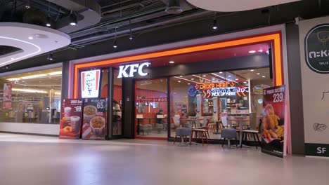 Customers-ordering-and-dinning-at-KFC-or-Kentrucky-Fried-Chicken,-inside-a-mall-in-Bangkok,-Thailand
