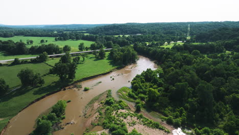 Brown-Waters-Of-Illinois-River-Through-Verdant-Foliage-In-Arkansas,-USA