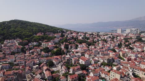 Flyover-aerial-city-of-Split-in-Croatia,-flying-above-typical-Croatian-houses