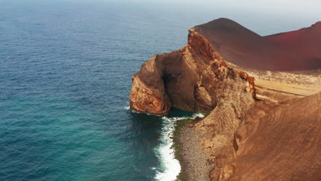 Aerial-drone-shot-of-majestic-red-colored-volcanic-coastline-in-the-Azores-Islands---Portugal