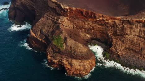 Aerial-drone-shot-of-majestic-red-colored-volcanic-coastline-in-the-Azores-Islands---Portugal